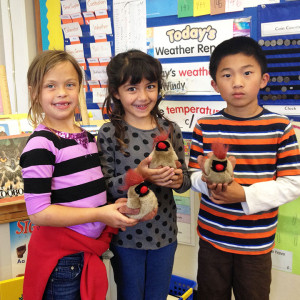 Smiling Children holding Musical Bird Puppets