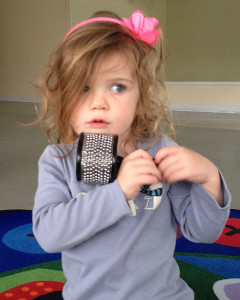 Young Girl Playing Musical Instrument Cabasa